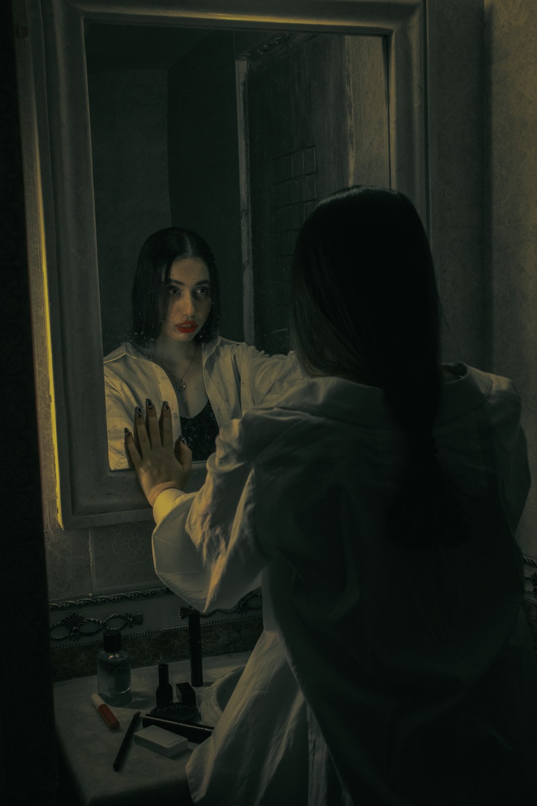 Photo by Navid Sohrabi a woman standing in front of a mirror